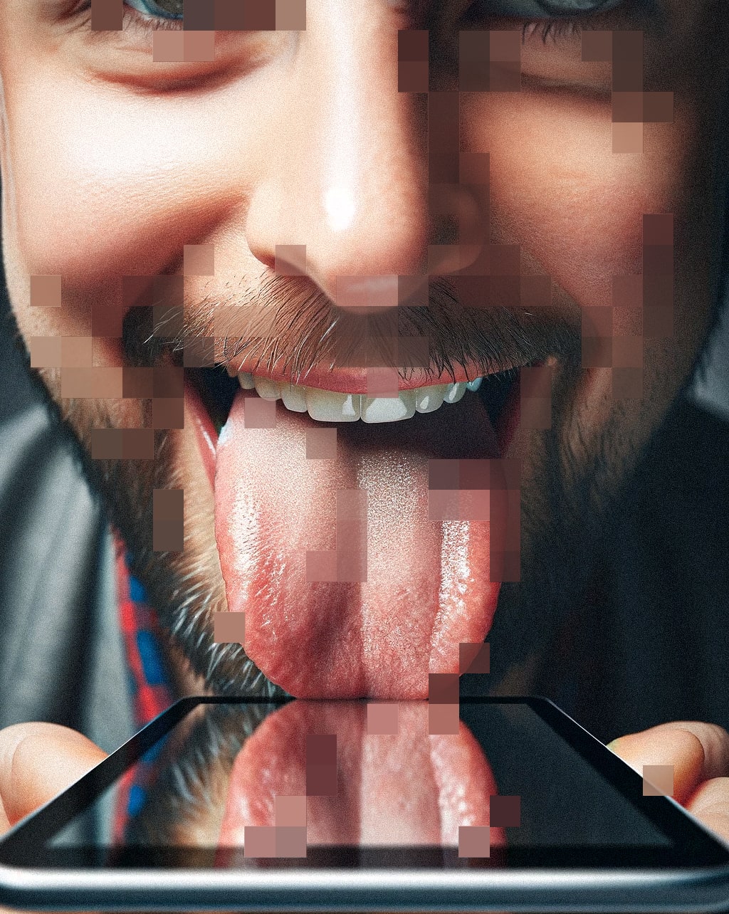 A closeup of a man licking his smartphone excitedly